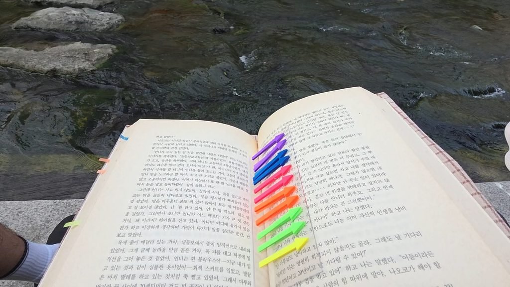 Reading by Cheonggyecheon at sunset, Seoul outdoor library