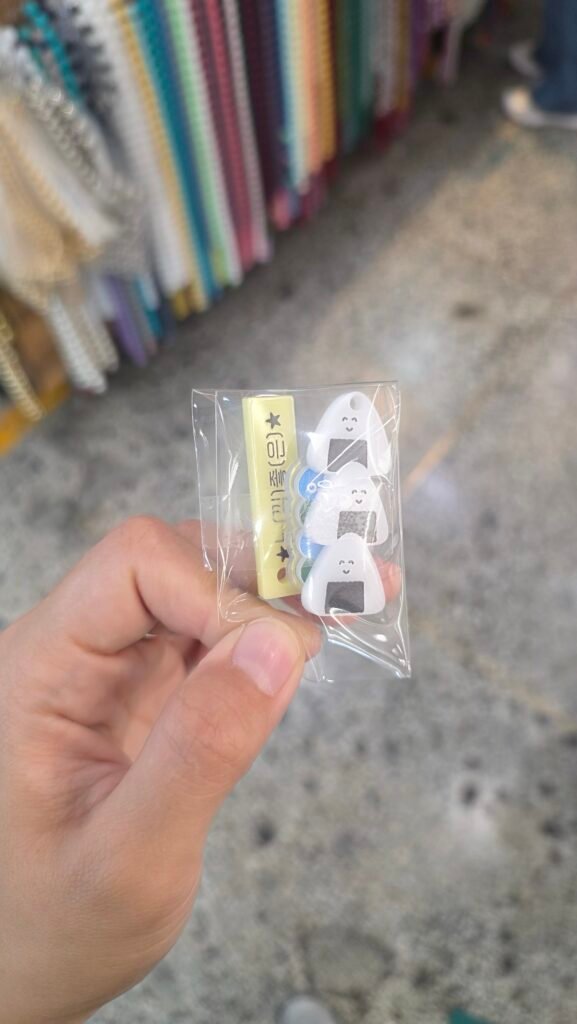 Hand holding diary charms bought at Dongdaemun Market